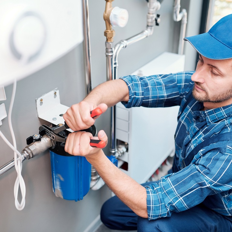 KLEIN 23 Young Man Workwear Using Pliers While Installing Water Filtration System Kitchen Client